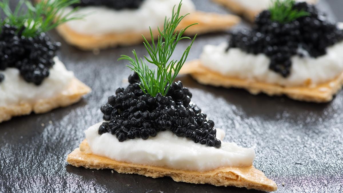 Article Cards Featured Image crackers with cream cheese and black caviar