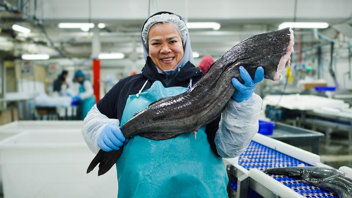 Copper River Seafoods Processor, Ada Morillo, displays an Alaska sablefish