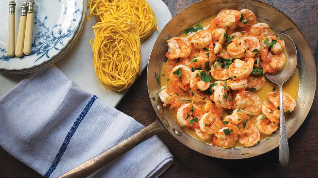 Pan full of sautèed shrimp in a pan.