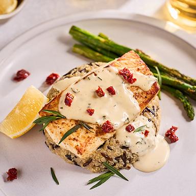 Copper River Seafoods broiled halibut with sauce on plate.